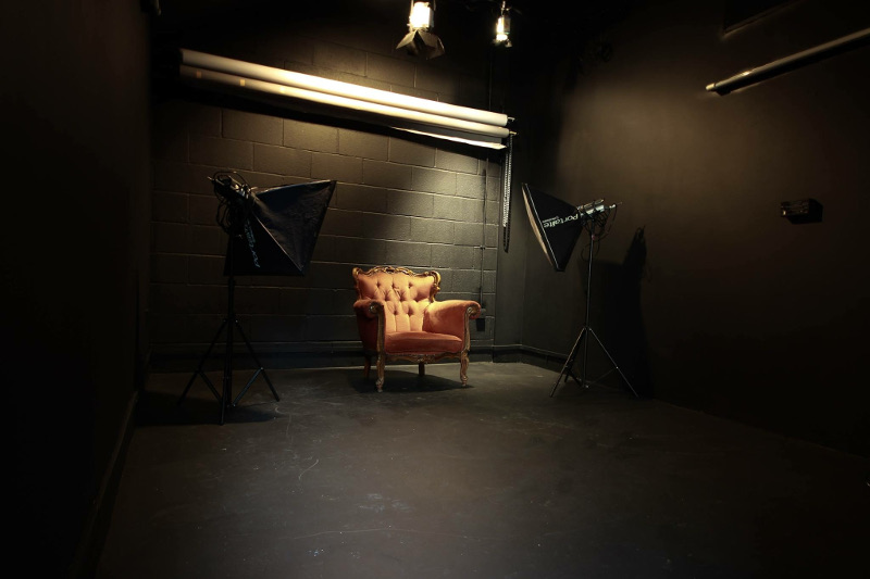 studio 2 black walls red chair spotlights white grey colorama paper